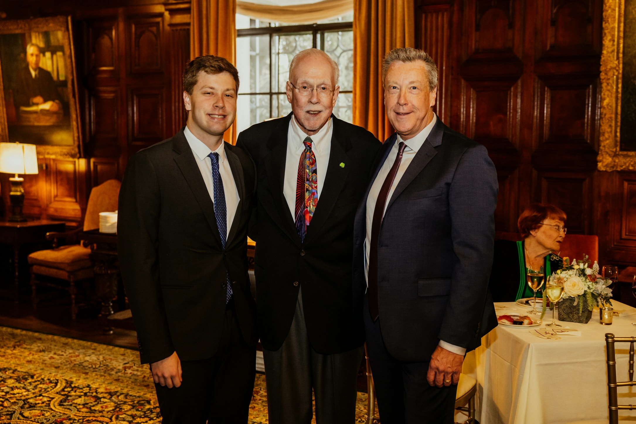 Three generations of the Gray family in business attire at a formal event